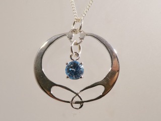 Silver Celtic pendant with blue topaz